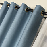Blue curtains with gold eyelets on a beige background