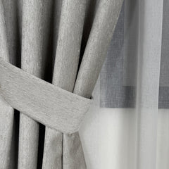 Close-up of gray curtains with a tieback